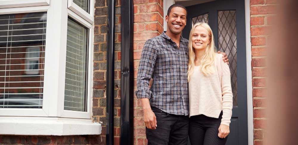 Happy couple with their first home after renting