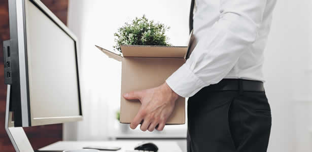 Man working in an office is made redundant 