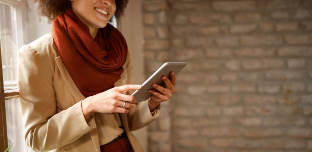 Woman using mobile device to check credit