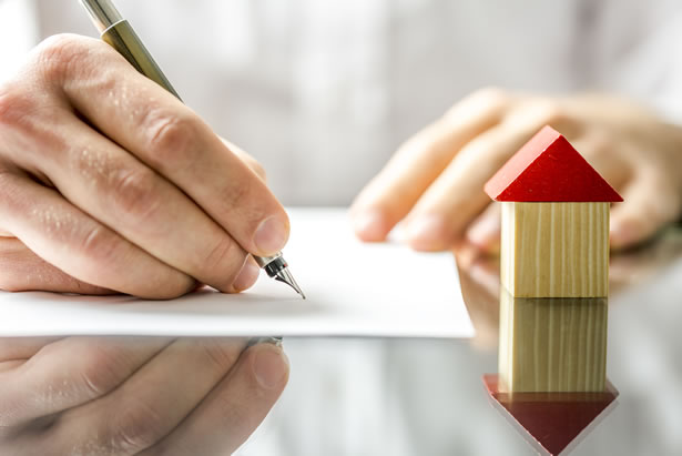 Person signing a contract for their new home